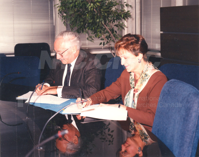 Signing of MOU by Dr. P.O. Perron of the NRC and Deputy Minister Lorette Goulet of the Federal Office of Regional Development, Feb. 15 1994 003